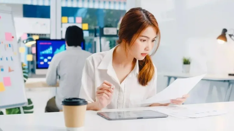 woman in white shirt studying business management from bolton university